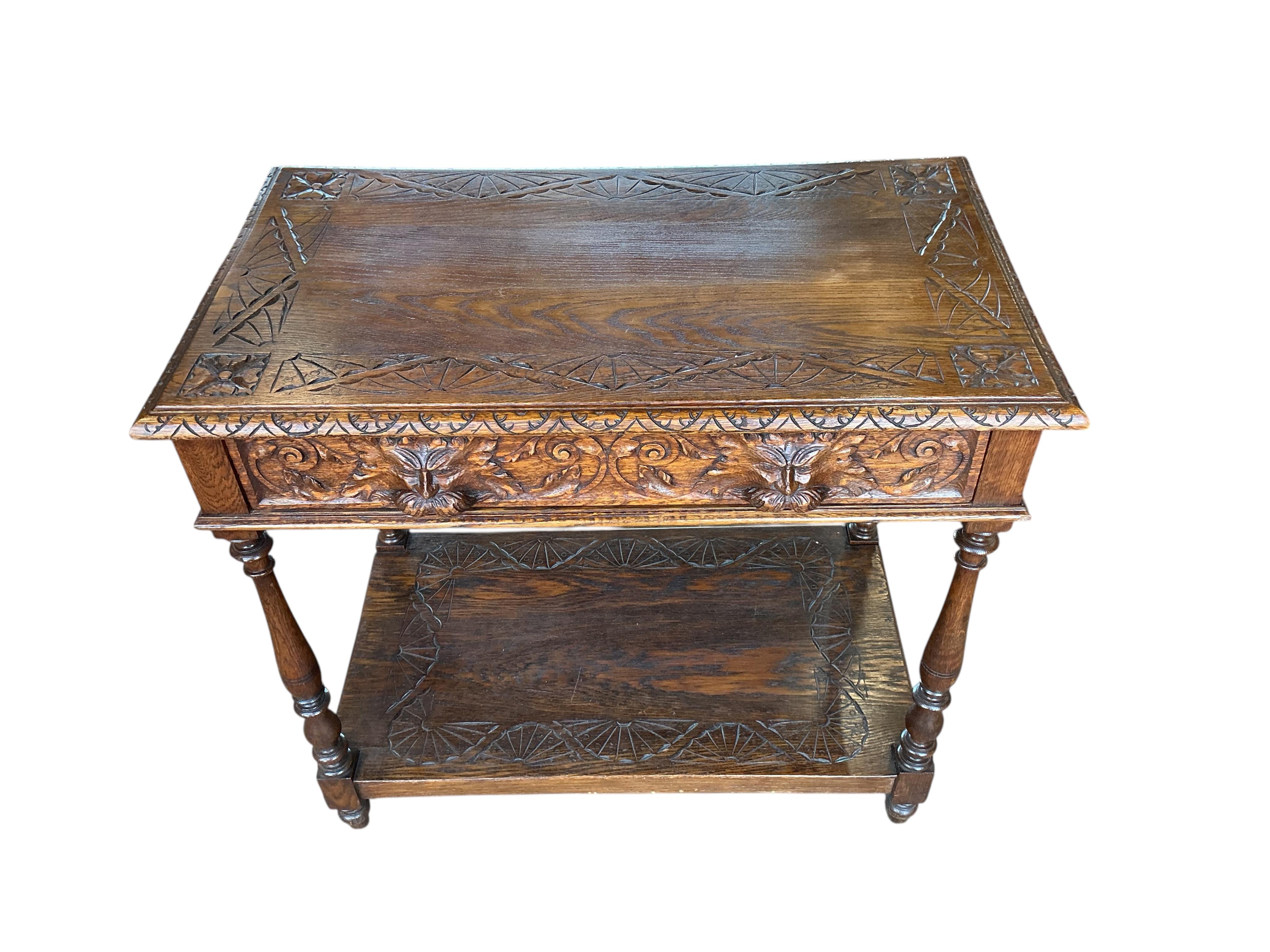 A late Victorian Flemish carved oak two tier table, width 84cm, depth 49cm, height 75cm